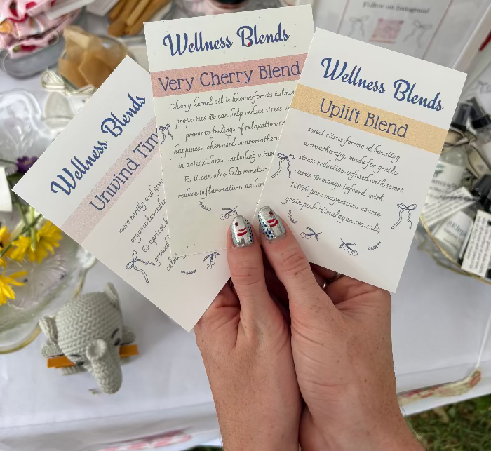 Hand holding wellness blend cards with a blurred background
