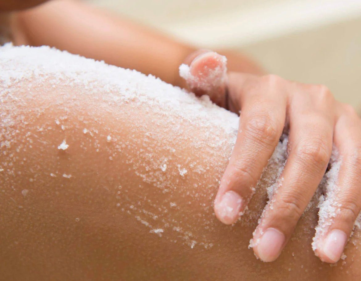 close up of a hand rubbing the salts onto the body