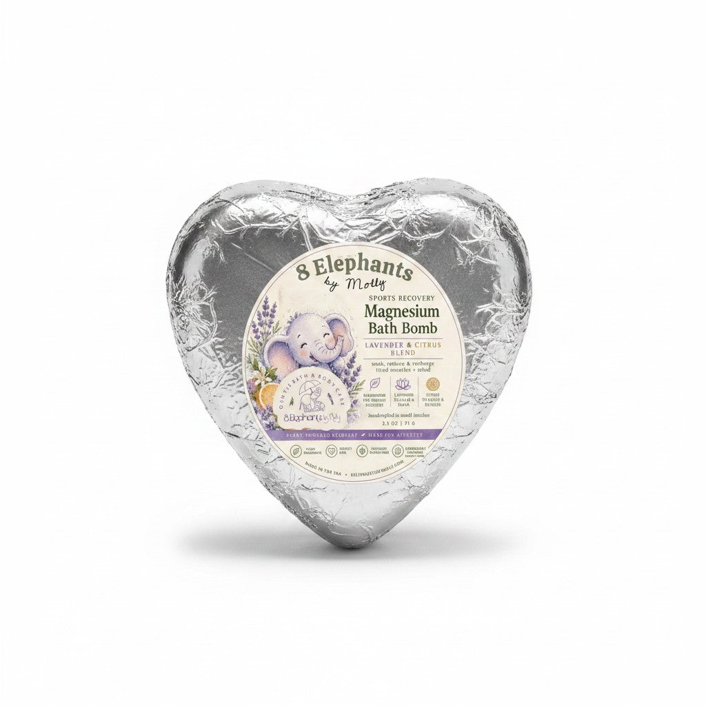 A heart-shaped silver foil-wrapped bath bomb package with a round label reading '8 Elephants by Mocha Magnesium Bath Bomb' on a clean white background.